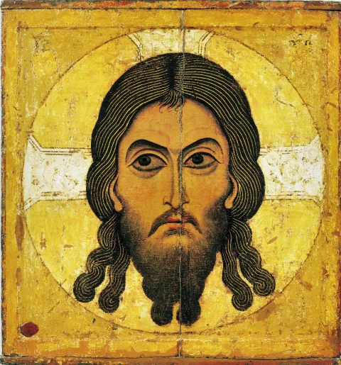 Икона Спаса Нерукотворного: лик Христа с крестчатым нимбом на светлом фоне.